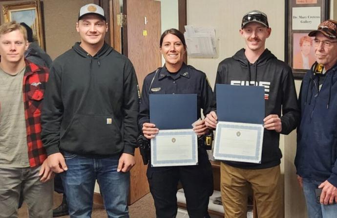 Courtesy photo Gladstone’s two recently-recognized service members stand with their family members. From left to right are Cole Potier, Hunter Potier, Public Safety Officer Charity Potier, Volunteer Firefighter Jayson Frandle and Troy Frandle.