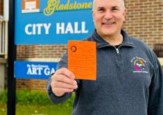 Code Enforcement Official, George Sailer, holds up spring clean-up voucher